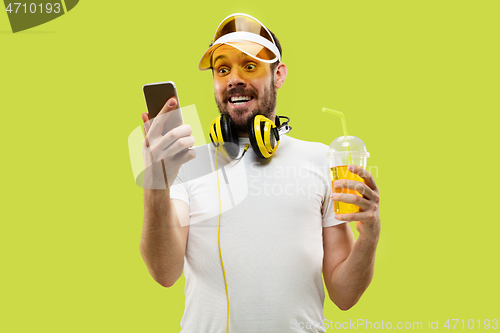 Image of Half-length close up portrait of young man on yellow background