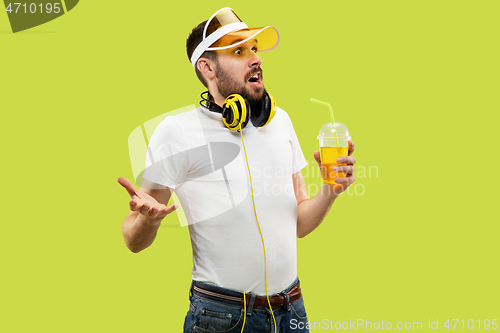 Image of Half-length close up portrait of young man on yellow background