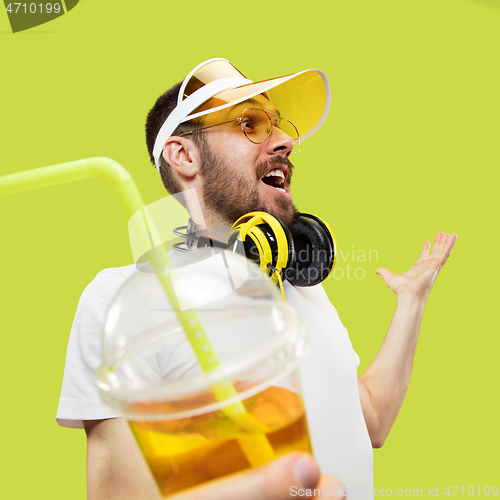 Image of Half-length close up portrait of young man on yellow background