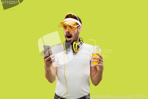 Image of Half-length close up portrait of young man on yellow background