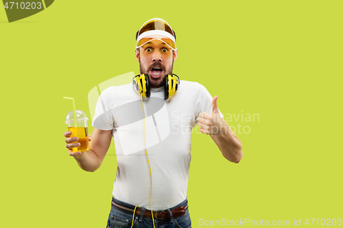 Image of Half-length close up portrait of young man on yellow background