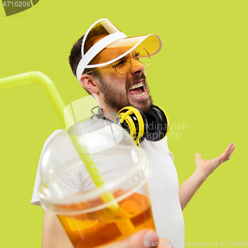 Image of Half-length close up portrait of young man on yellow background