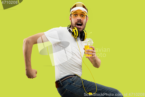 Image of Half-length close up portrait of young man on yellow background