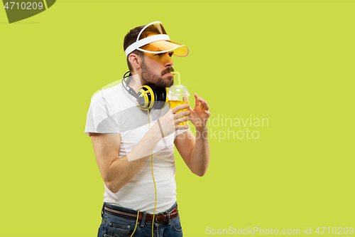 Image of Half-length close up portrait of young man on yellow background