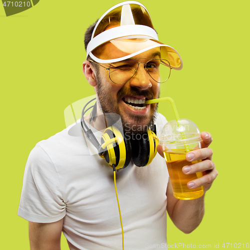 Image of Half-length close up portrait of young man on yellow background