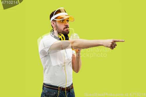 Image of Half-length close up portrait of young man on yellow background