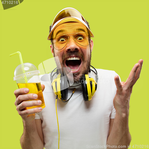 Image of Half-length close up portrait of young man on yellow background