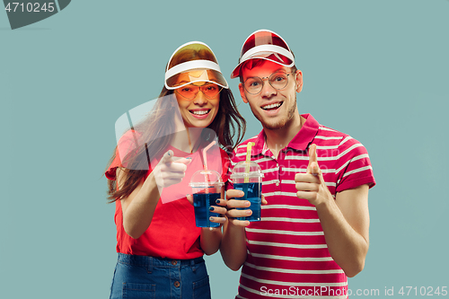 Image of Beautiful couple isolated on blue studio background