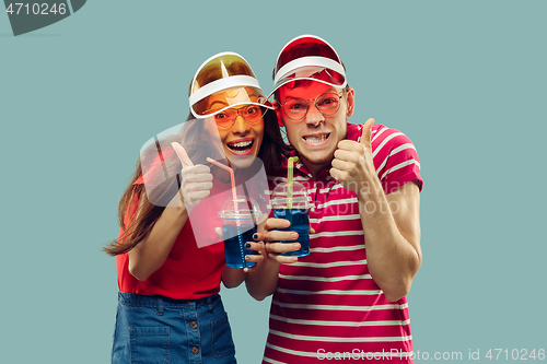 Image of Beautiful couple isolated on blue studio background