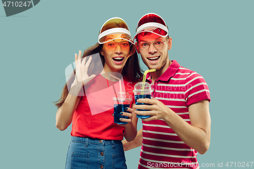 Image of Beautiful couple isolated on blue studio background