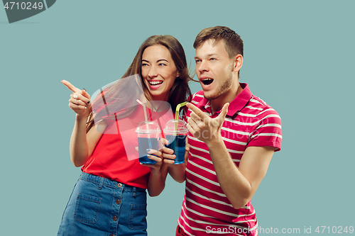 Image of Beautiful couple isolated on blue studio background