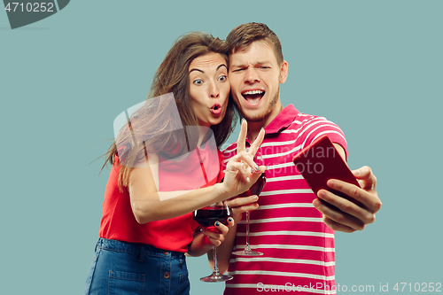 Image of Beautiful couple isolated on blue studio background