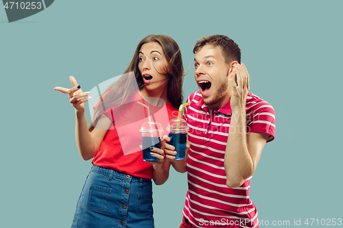 Image of Beautiful couple isolated on blue studio background