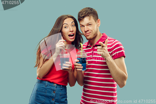 Image of Beautiful couple isolated on blue studio background