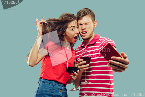 Image of Beautiful couple isolated on blue studio background