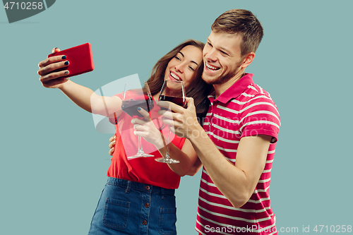 Image of Beautiful couple isolated on blue studio background