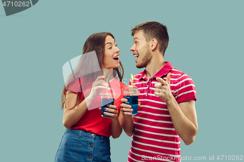 Image of Beautiful couple isolated on blue studio background