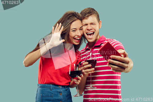 Image of Beautiful couple isolated on blue studio background