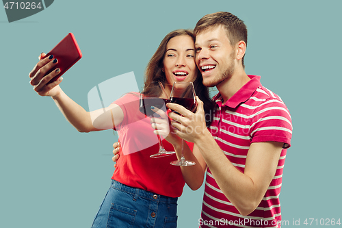 Image of Beautiful couple isolated on blue studio background