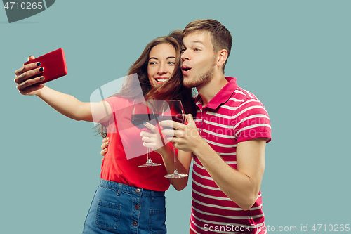 Image of Beautiful couple isolated on blue studio background