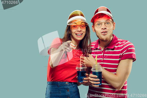 Image of Beautiful couple isolated on blue studio background