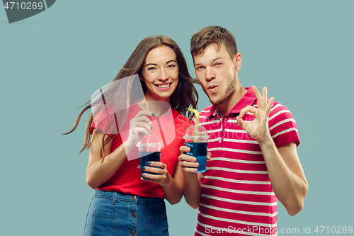 Image of Beautiful couple isolated on blue studio background