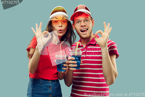 Image of Beautiful couple isolated on blue studio background