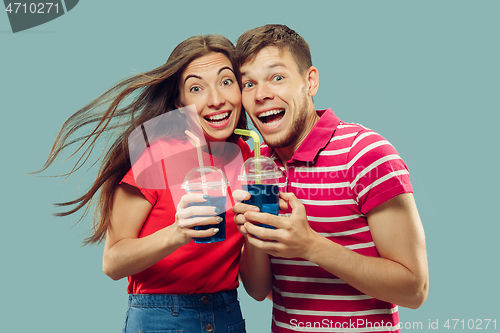 Image of Beautiful couple isolated on blue studio background