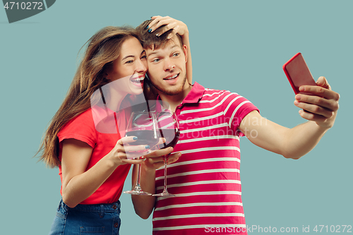 Image of Beautiful couple isolated on blue studio background