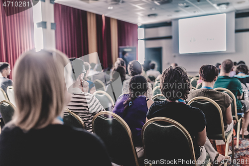 Image of Audience in lecture hall participating at business conference.
