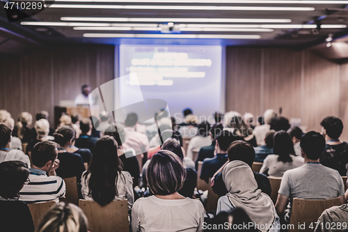 Image of Business speaker giving a talk at business conference event.