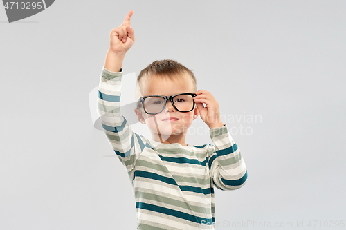 Image of portrait of boy in glasses pointing finger up