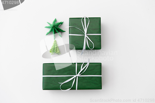 Image of gift boxes and christmas trees on white background