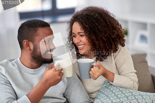 Image of african american couple drinking coffee at home