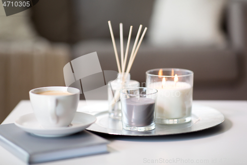 Image of coffee, candles and aroma reed diffuser on table