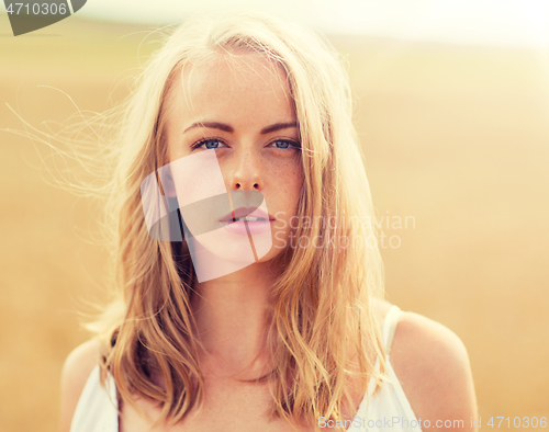 Image of young woman in white on cereal field