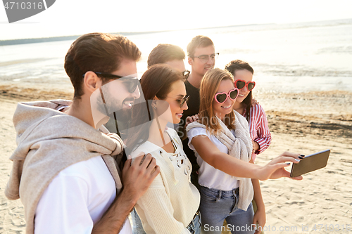 Image of happy friends taking selfie in summer