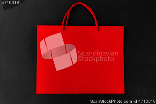 Image of red shopping bag on black background