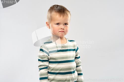 Image of portrait of sad little boy in striped shirt