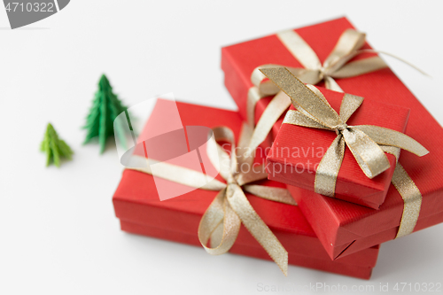 Image of gift boxes and christmas trees on white background