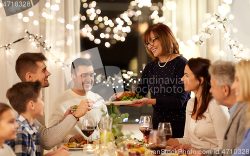 Image of happy family having dinner party at home