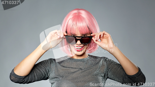 Image of happy woman in pink wig and black sunglasses