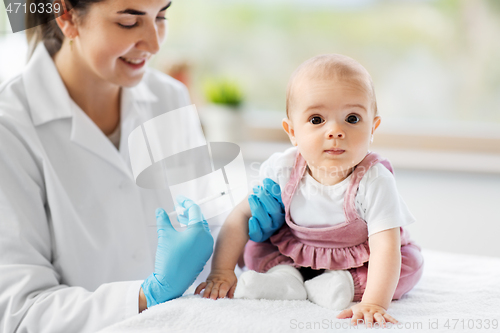 Image of doctor making vaccine for baby patient at clinic