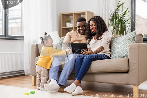 Image of african american family with tablet pc at home