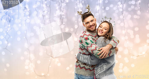 Image of happy couple at christmas ugly sweater party