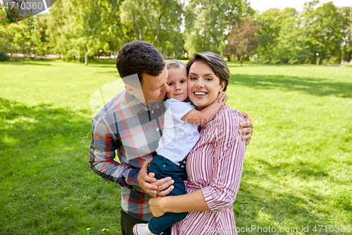 Image of happy family hugging at summer park