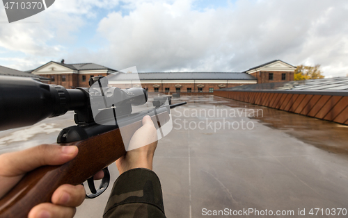 Image of POV of male hands shooting with air rifle