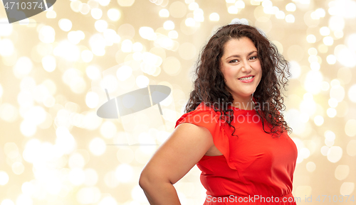 Image of happy woman in red dress over lights background