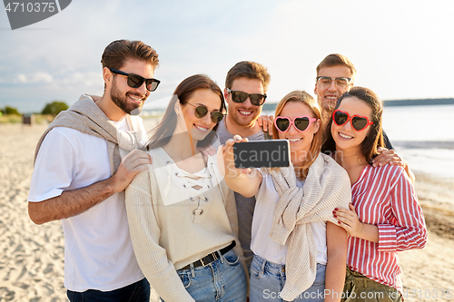 Image of happy friends taking selfie on summer beach