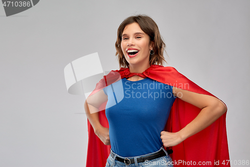 Image of happy woman in red superhero cape